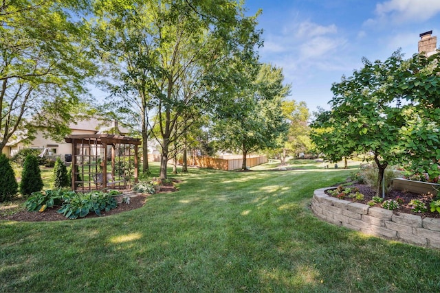 view of yard featuring a pergola and fence