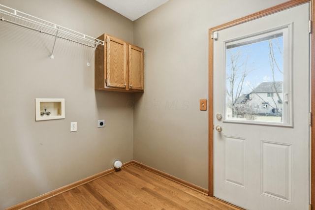 washroom featuring electric dryer hookup, light wood-type flooring, cabinet space, baseboards, and hookup for a washing machine