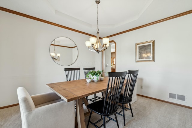 dining room with visible vents, light colored carpet, baseboards, and a tray ceiling