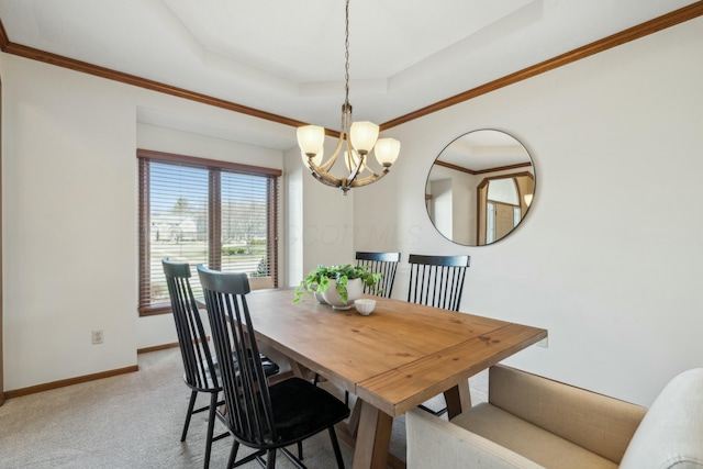 dining room featuring a tray ceiling, an inviting chandelier, crown molding, baseboards, and light colored carpet