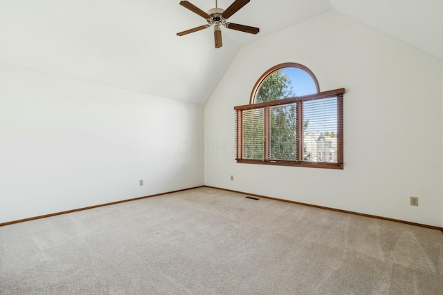 spare room with visible vents, baseboards, carpet floors, high vaulted ceiling, and a ceiling fan