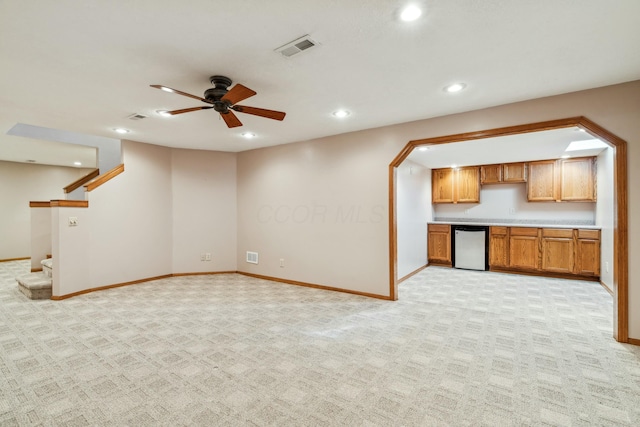 unfurnished living room featuring recessed lighting, visible vents, light colored carpet, and stairway