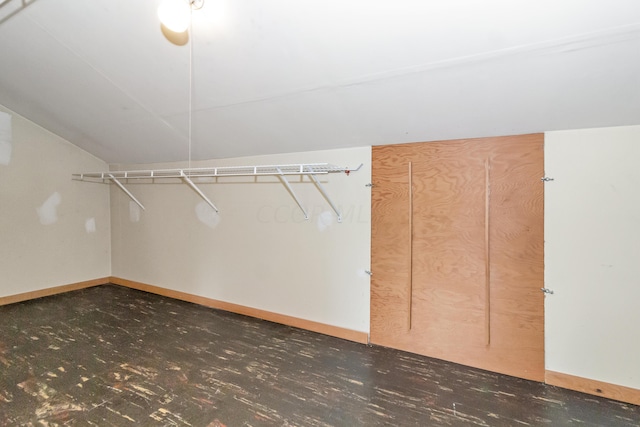 walk in closet featuring vaulted ceiling