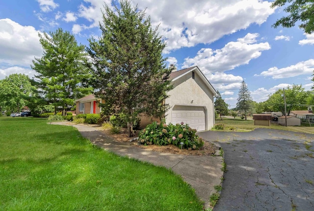 obstructed view of property featuring a front yard and a garage