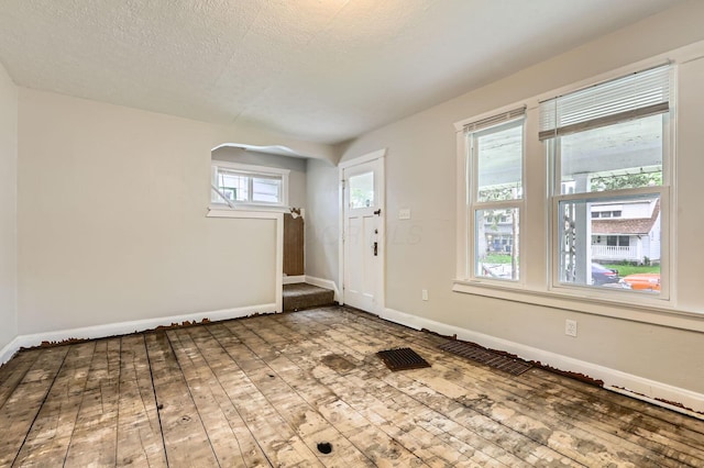 737 S Richardson Ave, Columbus, OH 43204 - foyer with hardwood / wood-style flooring, a textured ceiling, and arched walkways
