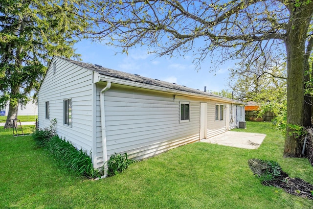 back of house featuring a lawn, central AC unit, and a patio