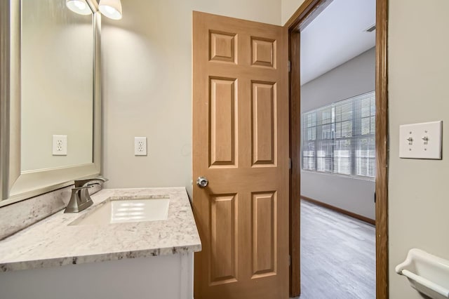 bathroom featuring vanity and wood finished floors