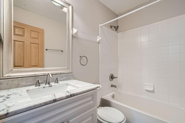 bathroom with toilet, tub / shower combination, and vanity