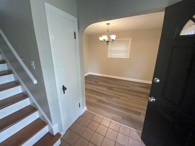 entrance foyer featuring hardwood / wood-style floors and a chandelier