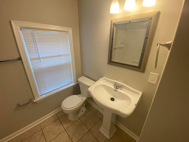 bathroom featuring tile patterned flooring, toilet, and sink