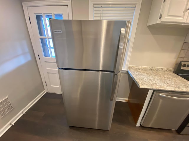 kitchen with white cabinets, dark hardwood / wood-style floors, and appliances with stainless steel finishes