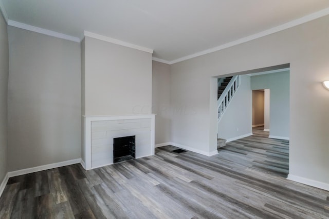 unfurnished living room with ornamental molding and hardwood / wood-style flooring