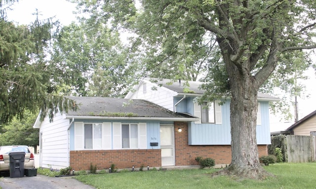 tri-level home with a front yard