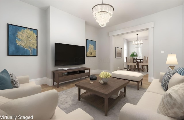 living room with a notable chandelier and light hardwood / wood-style flooring