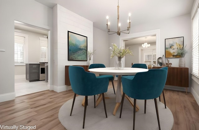 dining room featuring a notable chandelier and light hardwood / wood-style floors