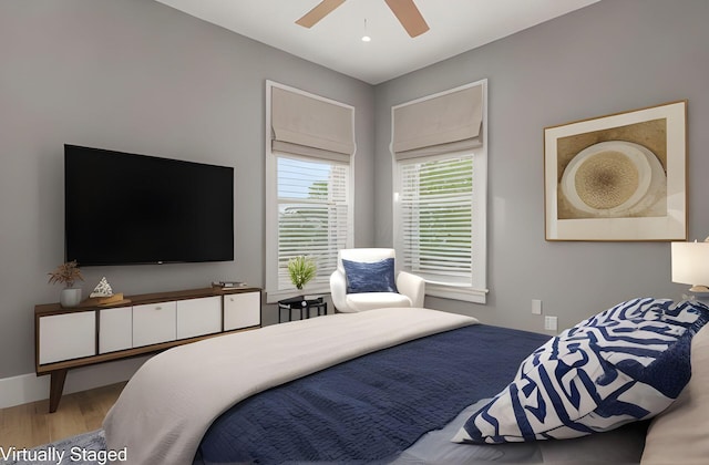 bedroom with ceiling fan and hardwood / wood-style floors