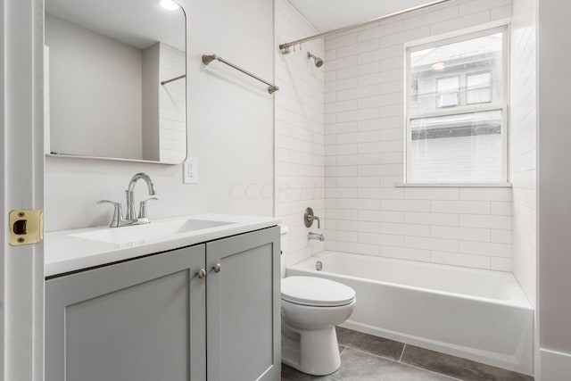 full bathroom with tiled shower / bath combo, toilet, vanity, and a wealth of natural light