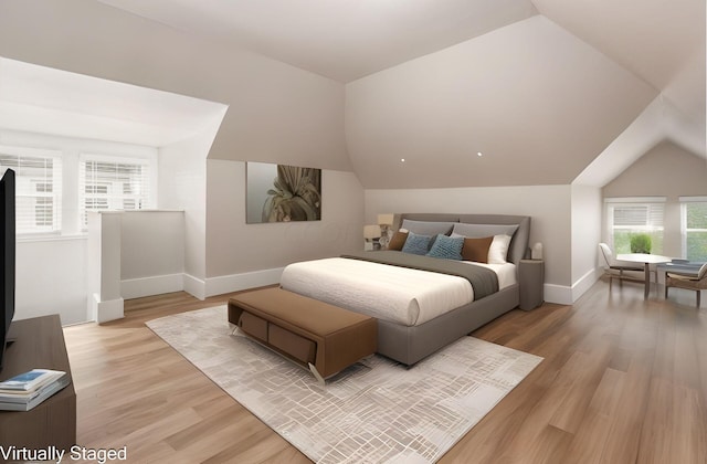 bedroom featuring lofted ceiling and light hardwood / wood-style flooring