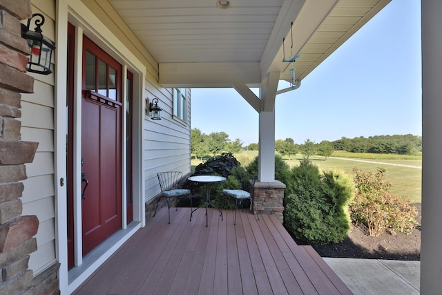 wooden terrace featuring covered porch