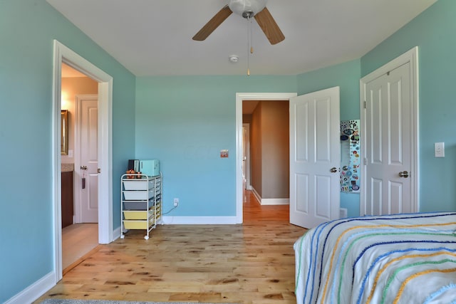 bedroom with light hardwood / wood-style floors and ceiling fan