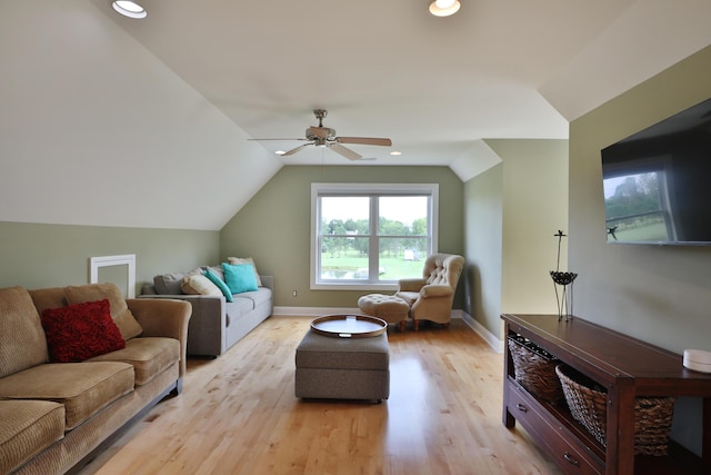 living room featuring ceiling fan, light hardwood / wood-style flooring, and vaulted ceiling