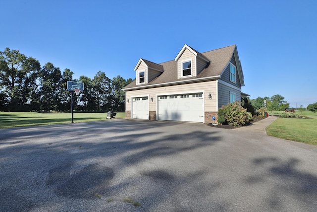 view of side of home featuring a yard and a garage