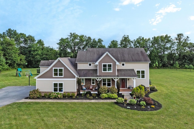 view of front facade with a front lawn and covered porch