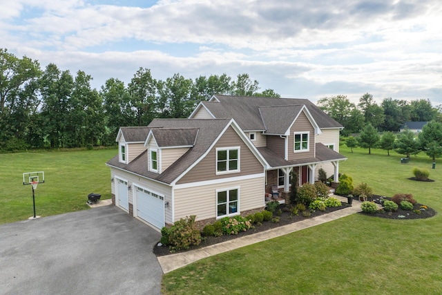 craftsman-style house featuring a porch, a front yard, and a garage