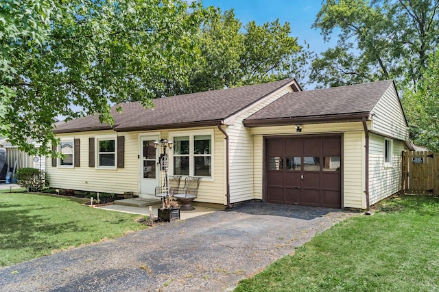 ranch-style home with a garage and a front lawn