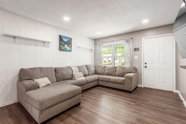 living room with wooden walls and dark hardwood / wood-style floors