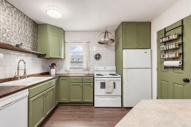 kitchen featuring decorative backsplash, dark hardwood / wood-style flooring, white appliances, sink, and green cabinets