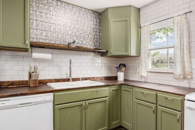 kitchen with white dishwasher, green cabinets, sink, decorative backsplash, and butcher block countertops