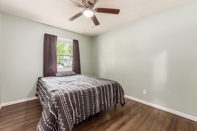 bedroom featuring dark hardwood / wood-style flooring and ceiling fan