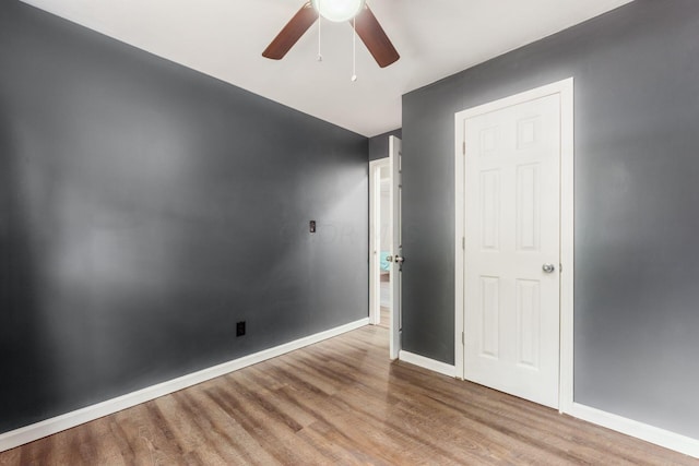 spare room with ceiling fan and light wood-type flooring