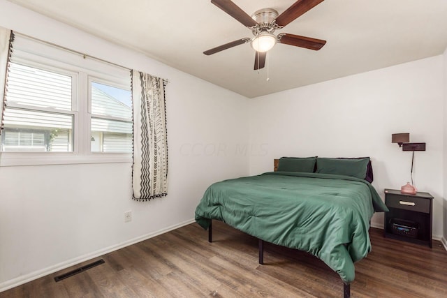 bedroom featuring ceiling fan and dark wood-type flooring