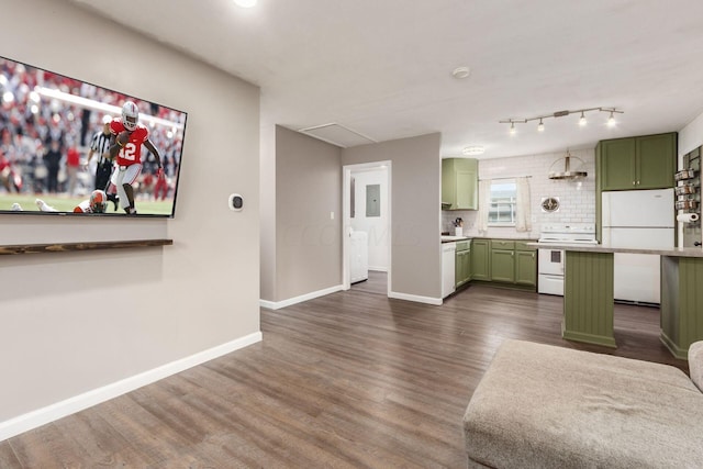 kitchen featuring green cabinets, wall chimney exhaust hood, dark hardwood / wood-style floors, and white appliances