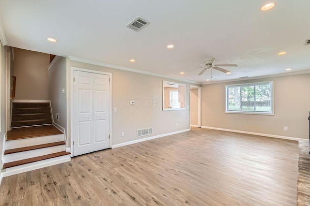 spare room with crown molding, a ceiling fan, stairway, recessed lighting, and light wood-type flooring
