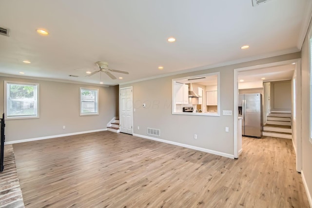 unfurnished living room featuring stairway, ornamental molding, a ceiling fan, recessed lighting, and light wood-style floors