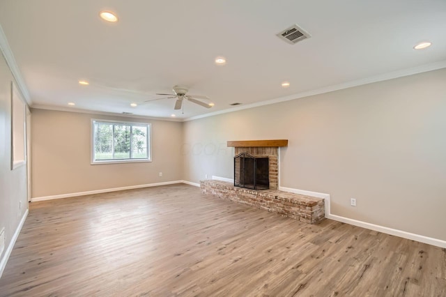unfurnished living room with crown molding, ceiling fan, recessed lighting, a fireplace, and wood finished floors