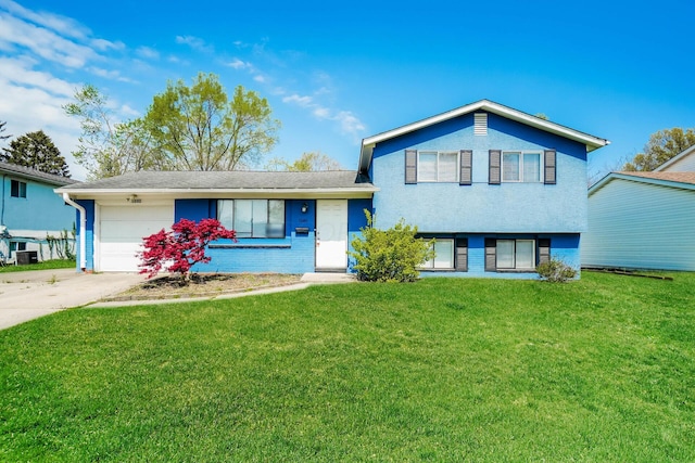 split level home with a garage and a front yard