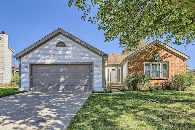 view of front of property with a garage and a front lawn