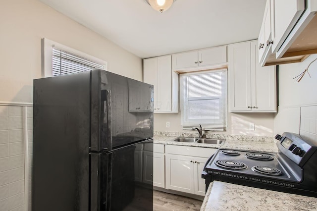 191 S Eureka Ave, Columbus, OH 43204 - kitchen featuring freestanding refrigerator, electric stove, white cabinets, and light wood finished floors