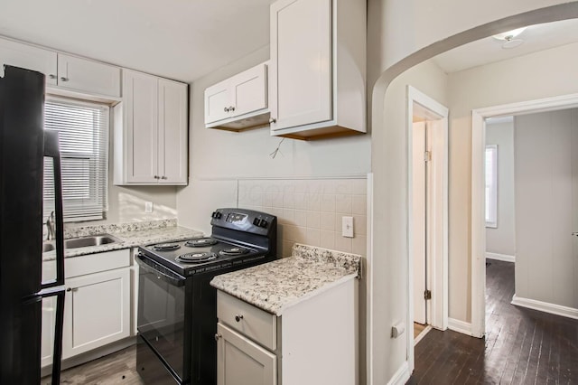 191 S Eureka Ave, Columbus, OH 43204 - kitchen with black appliances, dark wood-type flooring, arched walkways, and plenty of natural light