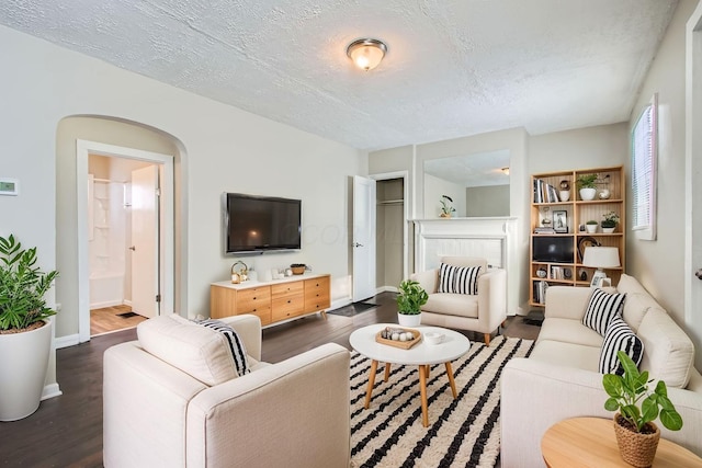 191 S Eureka Ave, Columbus, OH 43204 - living room featuring wood finished floors, a textured ceiling, and arched walkways