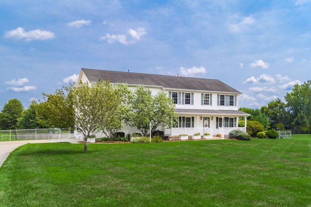 colonial-style house with a front lawn and covered porch