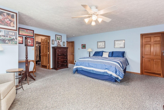 bedroom featuring carpet, a closet, a spacious closet, and ceiling fan