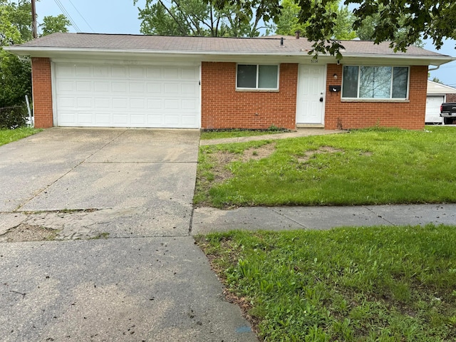 5114 Carbondale Dr, Columbus, OH 43232 - view of front of house featuring brick siding, a front yard, driveway, and roof with shingles