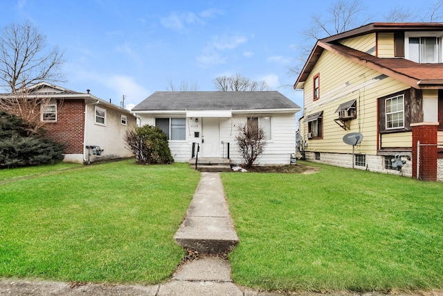 bungalow-style home featuring a front lawn