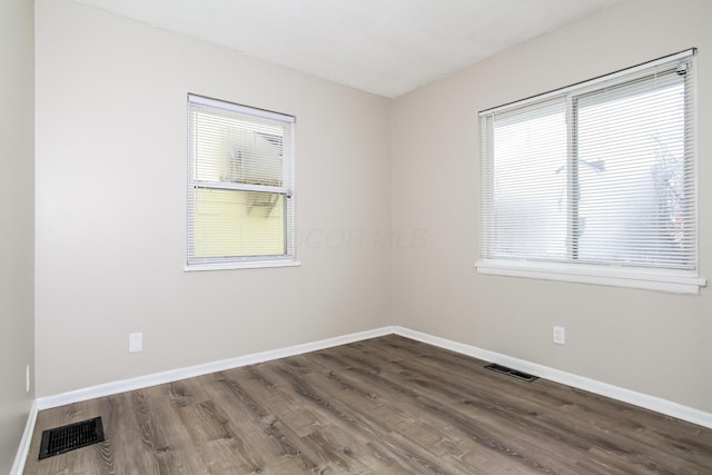 unfurnished room featuring hardwood / wood-style flooring