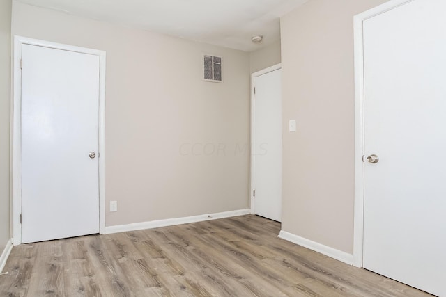 unfurnished bedroom with light wood-type flooring